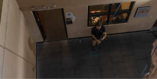 Student belaying a climber.