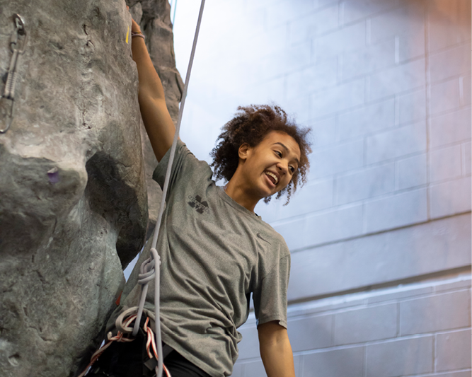 Student on climbing wall