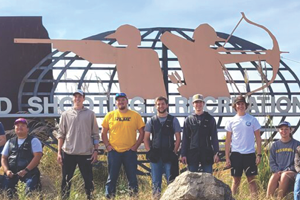 Students in front of shotgun sign