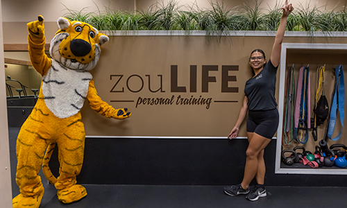 Truman and personal trainer in front of ZouLife.