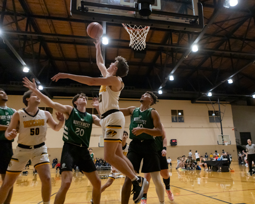 Intramural athlete shooting basket.